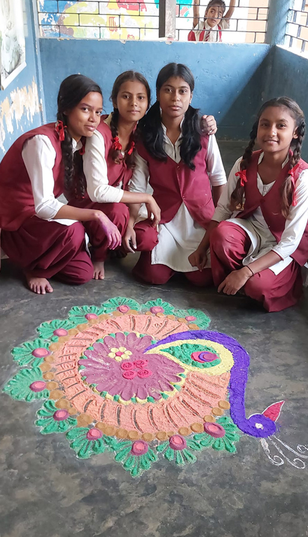 Four Girls Showing Their Sand Painting of a Peacock