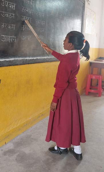 Student at the board taking a Hindi lesson
